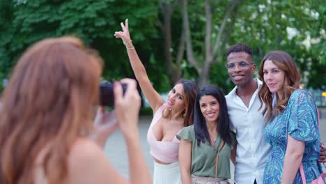 friends taking a group photo in a park