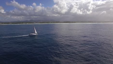 sailing yacht and island coast aerial shot