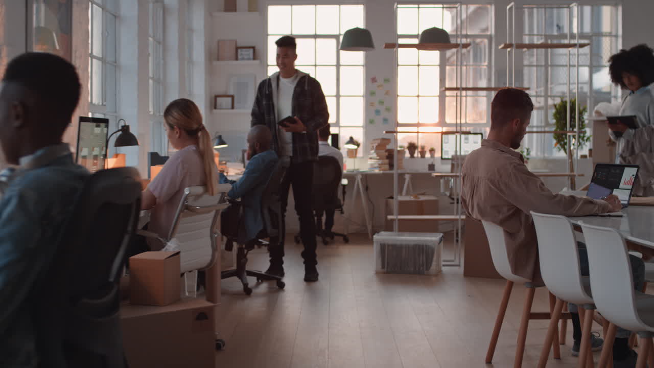 young asian businessman working late software developer meeting client shaking hands collaborating with intern on designing mobile application in office at sunset