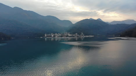 arial drone shot of sun moon lake and ita thao early in the morning just before sunrise