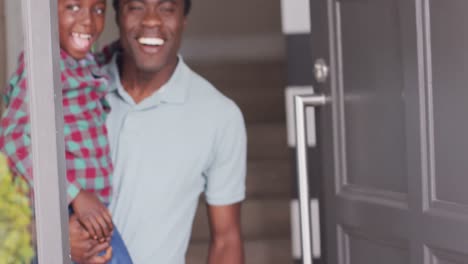 Portrait-of-happy-african-american-father-and-son-at-door