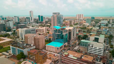 Traffic-and-cityscape-of-Victoria-Island,-Lagos,-Nigeria-featuring-Falomo-Bridge,-Lagos-Law-school-and-the-Civic-centre-tower