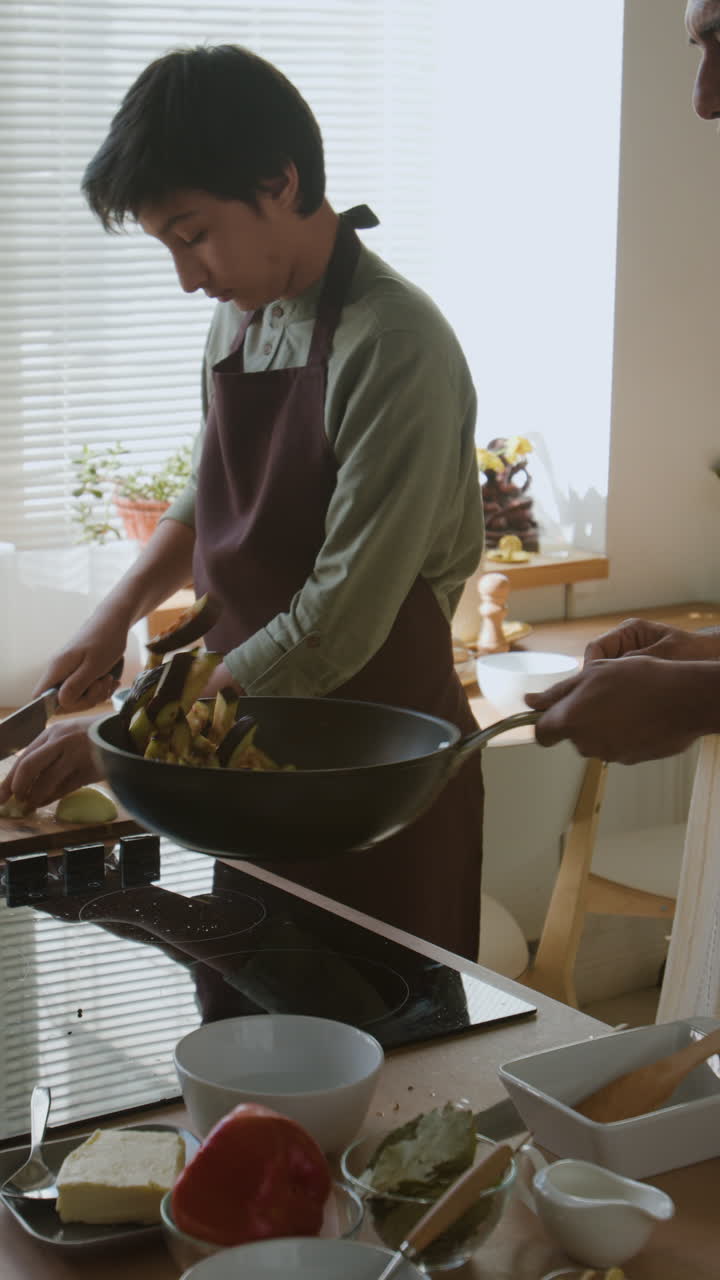 Father and Son Cooking Together in the Kitchen