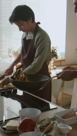 father and son cooking together in the kitchen