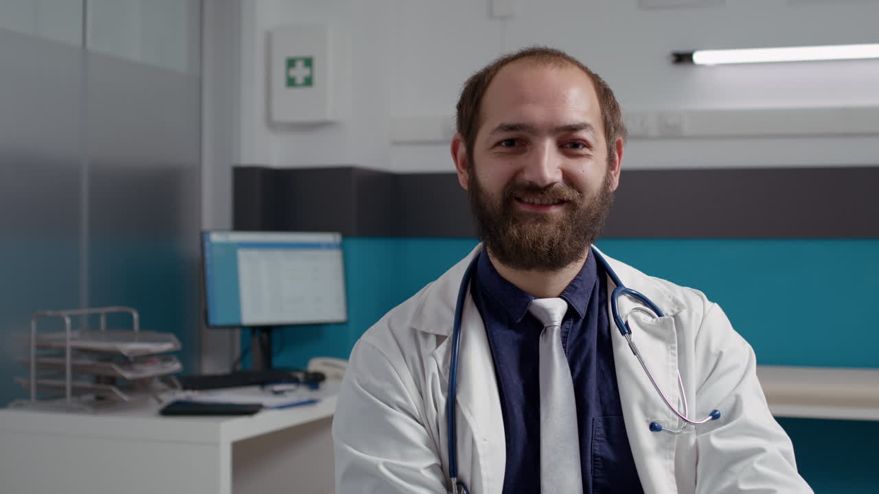 Portrait of general practitioner working on laptop in medical office