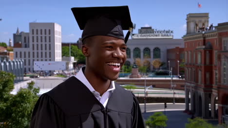 happy young man in graduation cap and gown