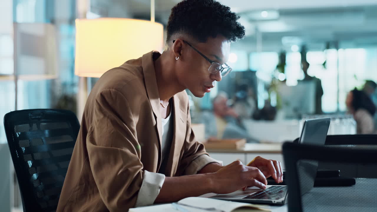 Young man working on laptop in modern office