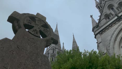 time lapse of a christian cross tombstone in front of a catholic cathedral