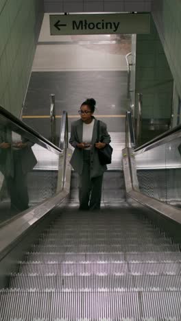 woman on escalator in metro station