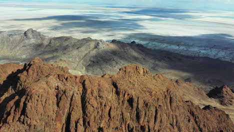 Steep-Rocky-Cliffs-Above-Desert-Landscape-of-Utah-Drone-Aerial-View-on-Sunny-Day-at-Bonneville-Salt-Flats