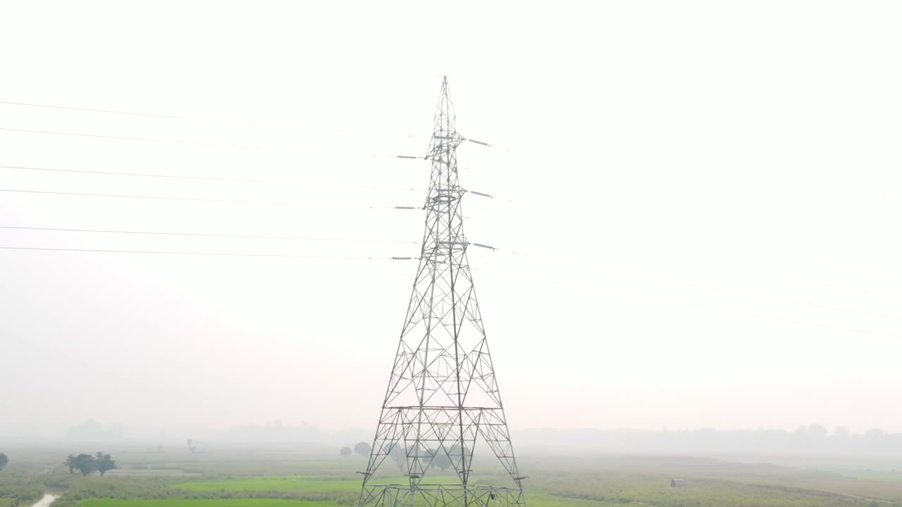 view footage of high voltage electricity tower and power lines under the smoky sky
