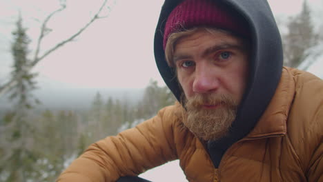 portrait of male tourist in mountains on winter day