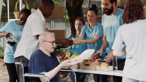 charity workers giving food to homeless