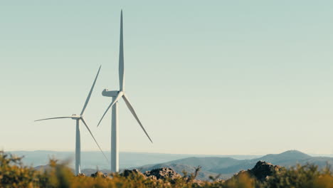 the blades of wind turbines at rest, waiting to harness the power of the wind to generate clean energy in a picturesque mountain setting