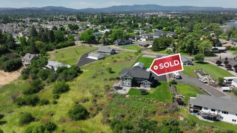 sold sign appearing over an upper class house in america