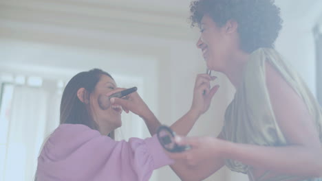 two female friends doing makeup on each other, having fun