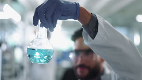 scientist holding a flask in a lab
