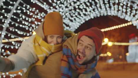 Joyous-Man-Giving-Piggyback-Ride-to-Girlfriend-with-Christmas-Sparkler
