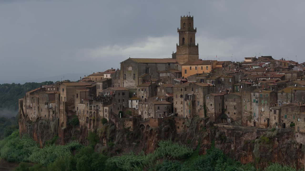 Pitigliano Italy, cliffside medieval town, telephoto drone view, overcast moody weather