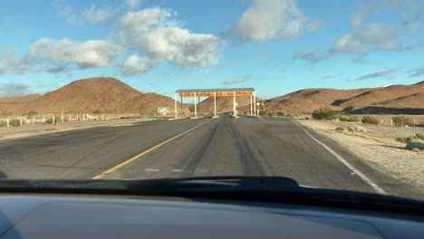 Deserted-checkpoint-in-dry-climate-passenger-side-POV-inside-car