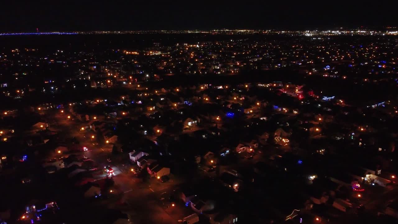 City lights illuminate houses and streets in St Constant, Quebec, creating a mesmerizing nightscape. Aerial Dolly