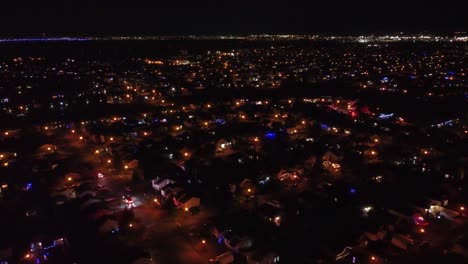 city lights illuminate houses and streets in st constant, quebec, creating a mesmerizing nightscape. aerial dolly