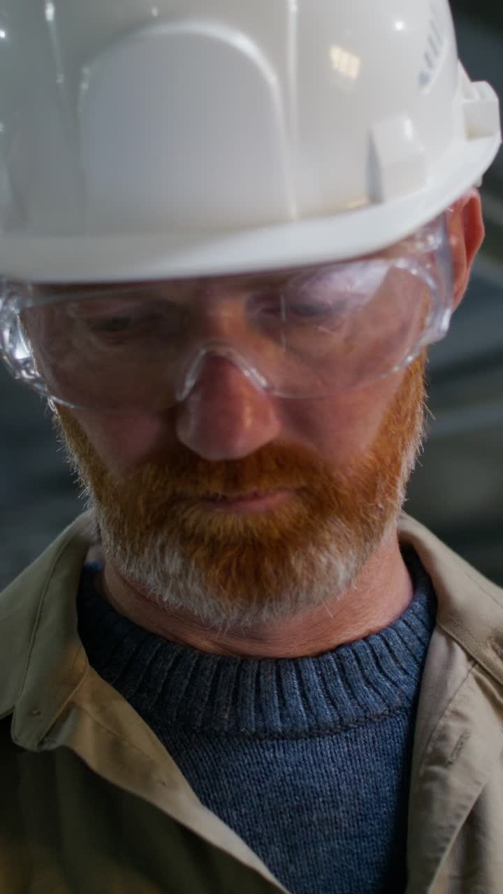 Worker using a tablet and safety equipment