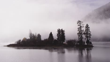 foggy dramatic scene looking across swan lake in montana