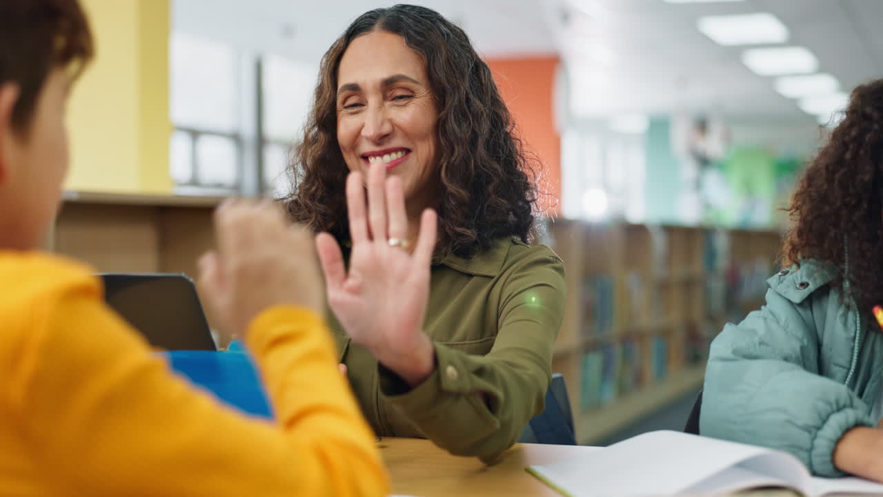 Teacher giving student a high five in classroom
