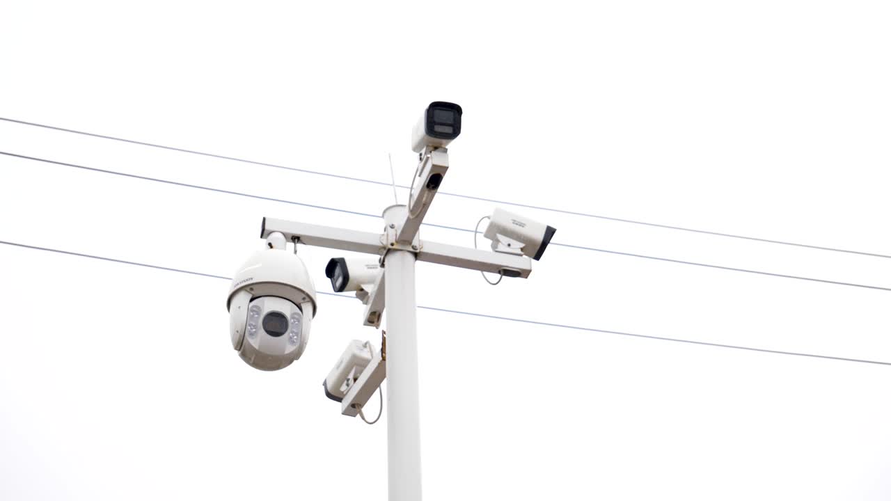 View of outdoor CCTV surveillance cameras mounted on a pole, observing the surroundings in China. Showcasing modern security technology and monitoring infrastructure.