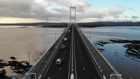 drone shot following along the severn bridge linking england with wales near to bristol, uk