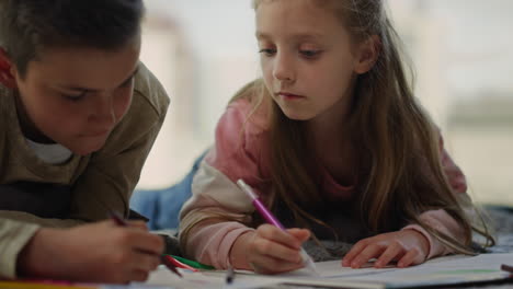 Brother-and-sister-drawing-with-colored-pencils