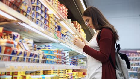woman shopping for dairy products in a grocery store