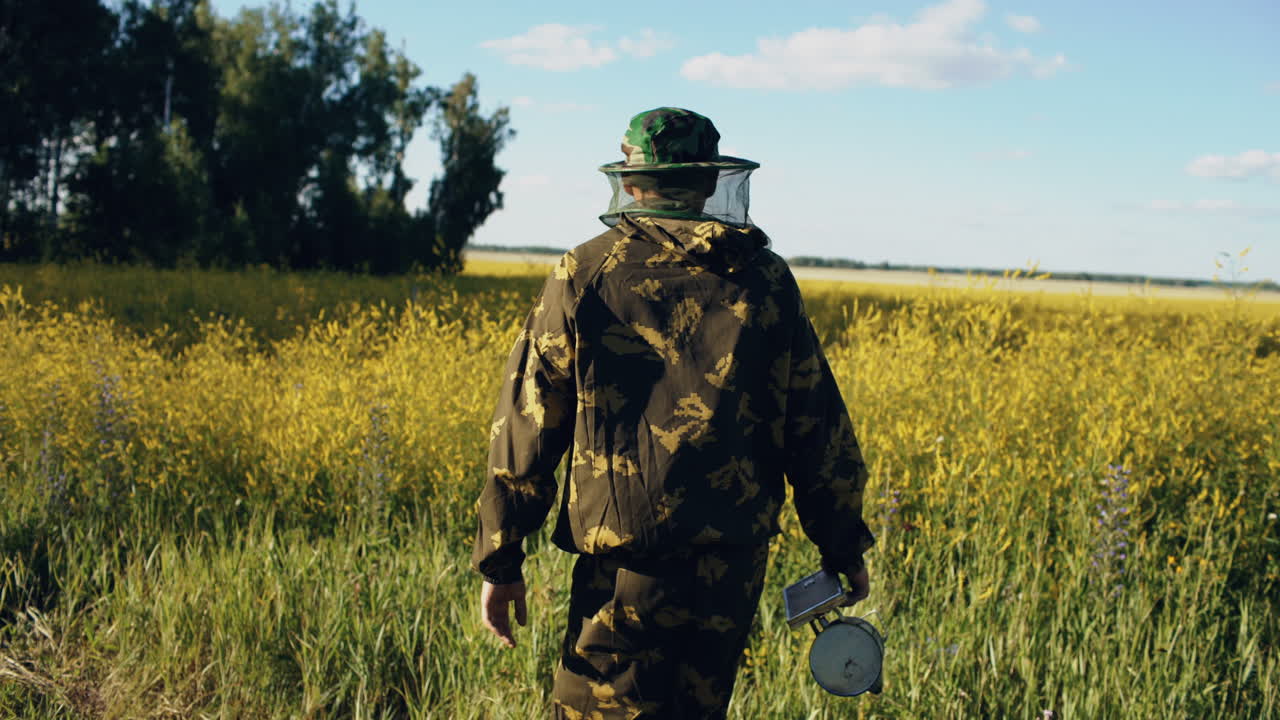 Beekeeper working in a field
