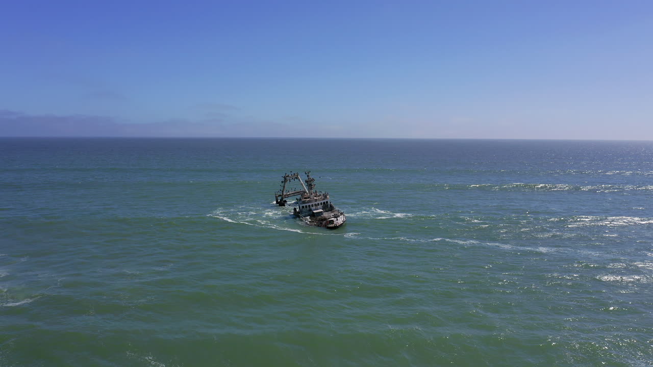 Slow panning drone shot of the rusted remains of the Zeila Shipwreck stranded off Namibia’s Skeleton Coast