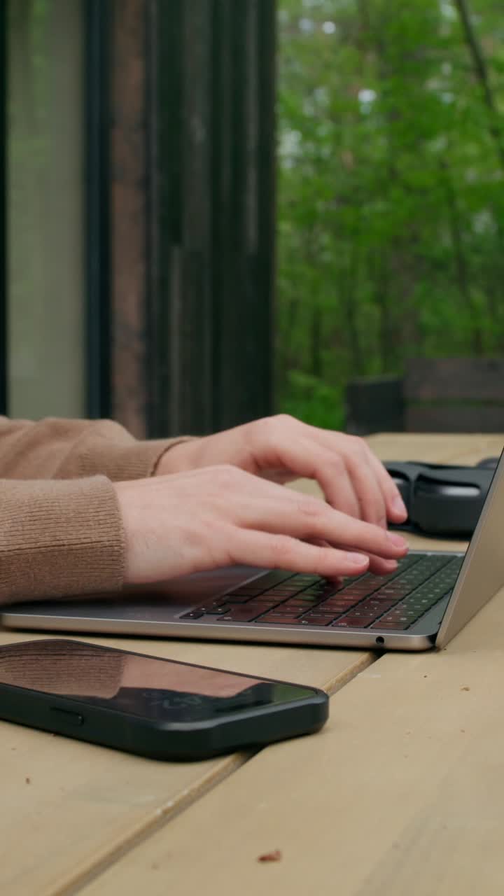 Woman working on a laptop outdoors