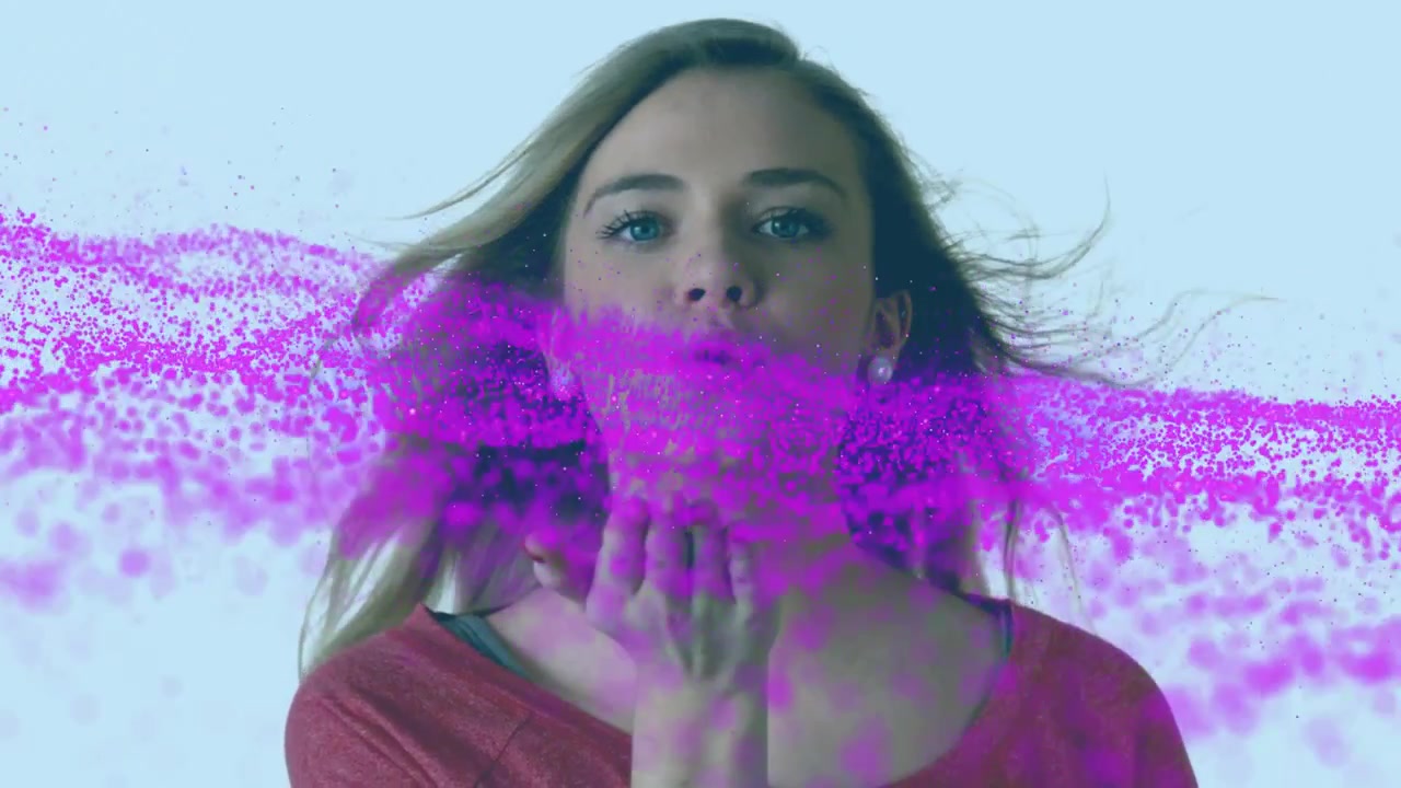 Woman cupping then blowing as left magenta particle ribbon meeting hand and dispersing for tech