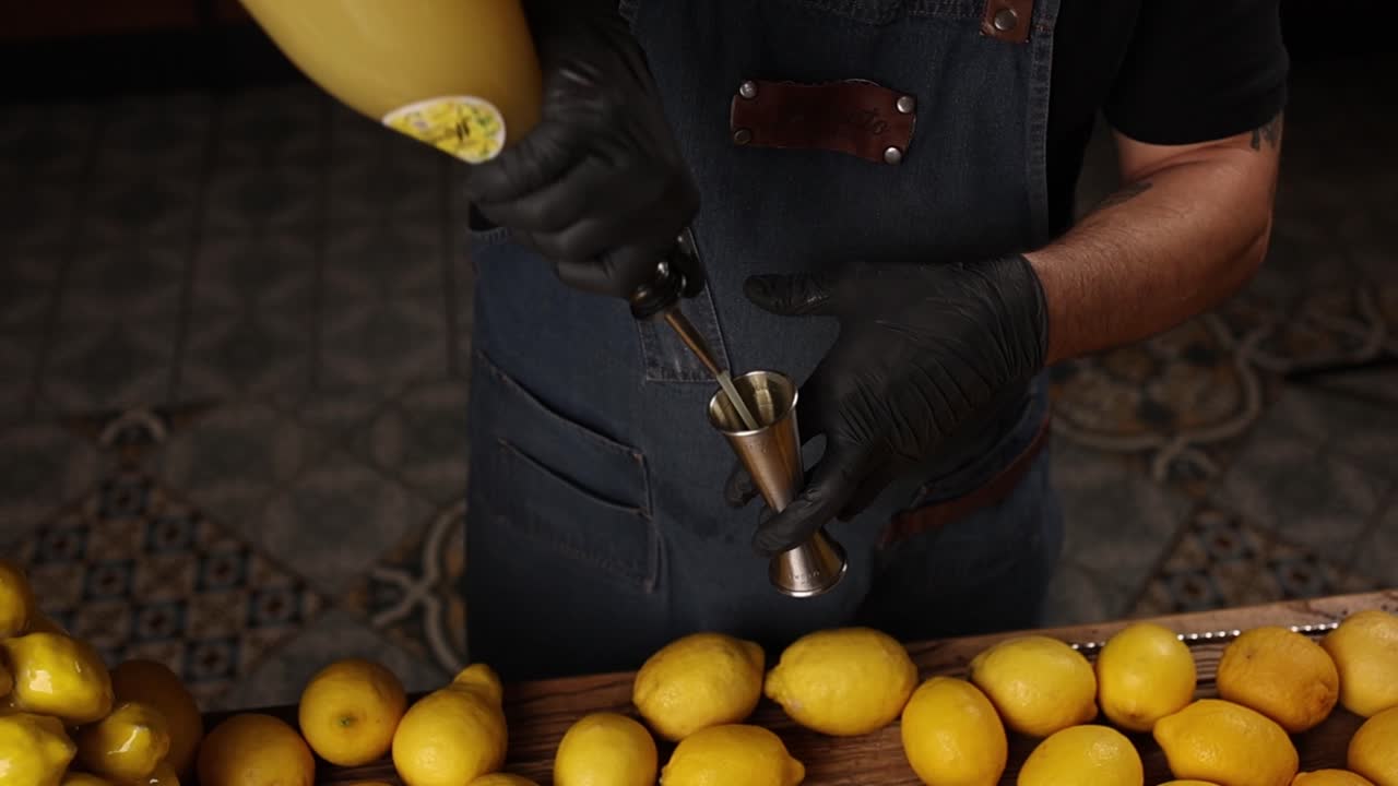 Bartender preparing a cocktail with lemons