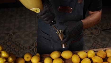 bartender preparing a cocktail with lemons