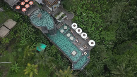 flyover multi level swimming pool with waterfall on tropical hillside