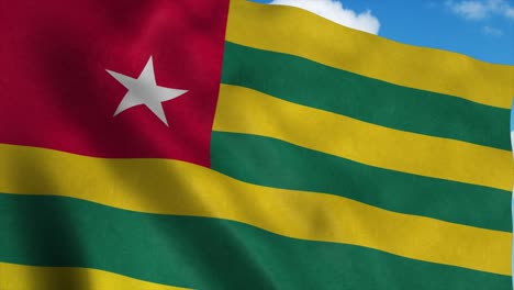 togo flag waving in the wind, blue sky background. 4k