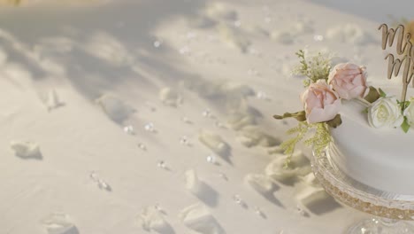 Close-Up-Of-Wedding-Cake-On-Decorated-Table-At-Wedding-Reception