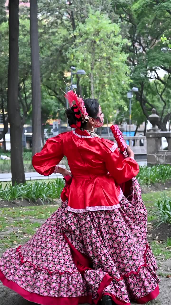 Woman in Traditional Mexican Dress Dancing in a Park