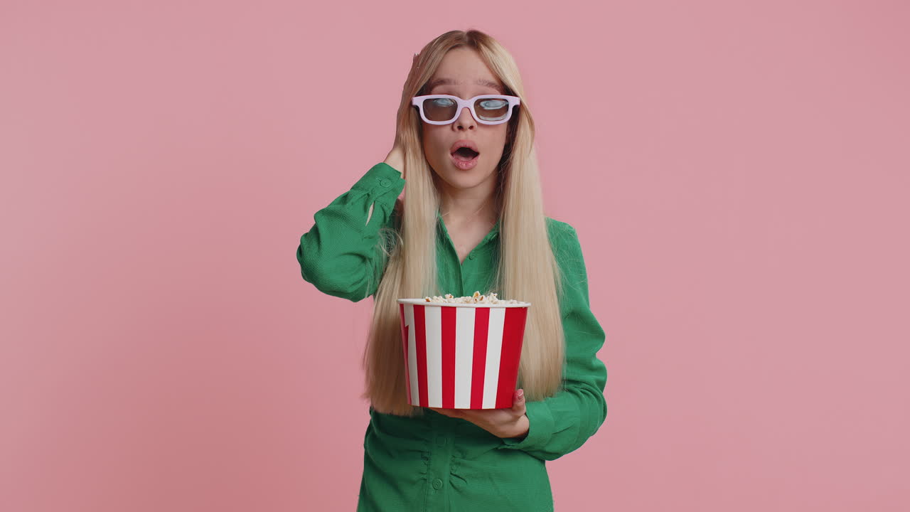 Woman in 3d glasses eating popcorn and watching interesting tv serial sport game film online movie