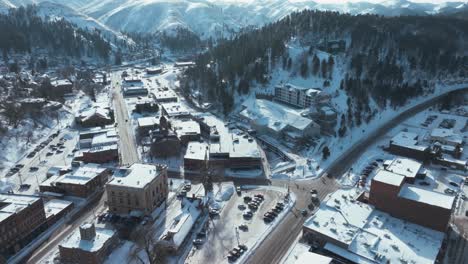 Flying-backwards-over-and-revealing-Deadwood,-South-Dakota-in-winter