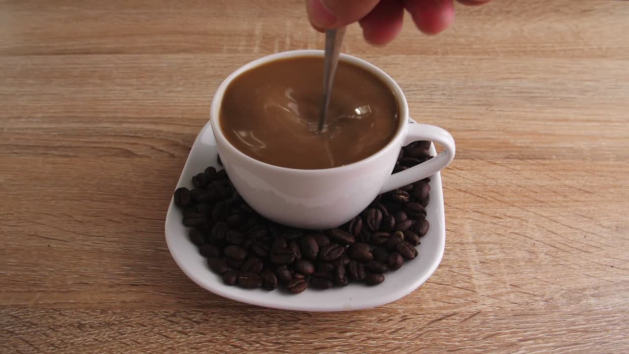 Coffee Being Stirred in a Cup