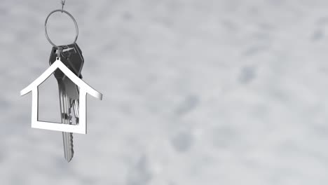 animation of silver key with house keychain on grey background