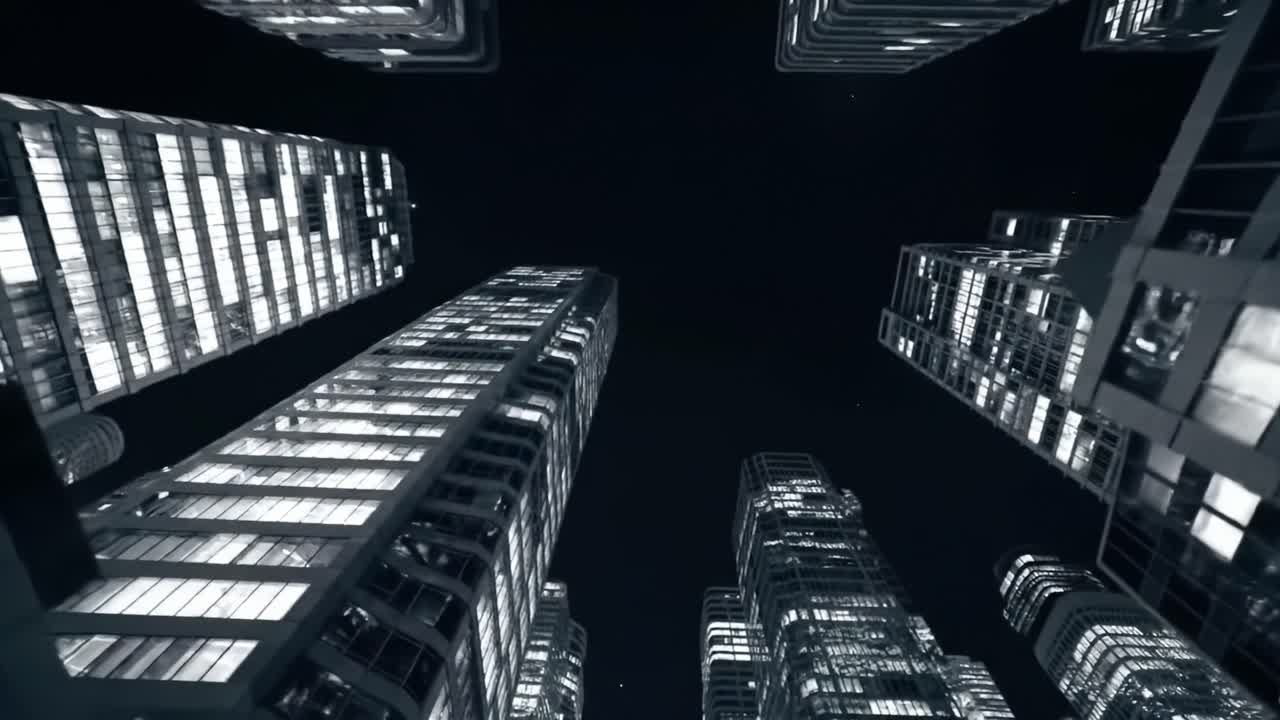 A Stunning Night View of Modern Skyscrapers Illuminated Against the Dark Sky, Showcasing Architectural Marvels Surrounded by Glass and Steel at Twilight.