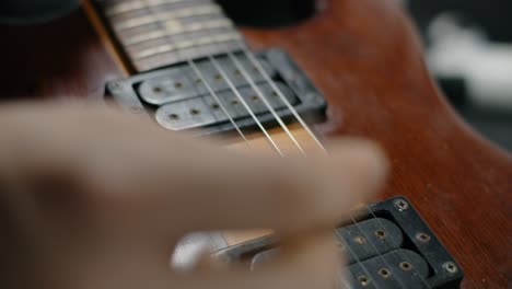 close-up of hands playing electric guitar