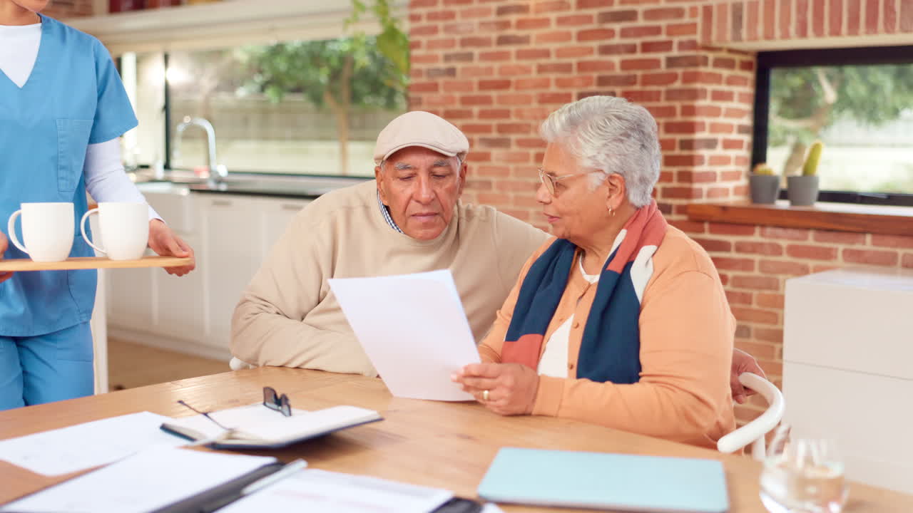 la enfermera discute los documentos con la pareja de mayores